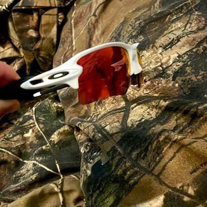 White and black Oakley’s with red lenses.